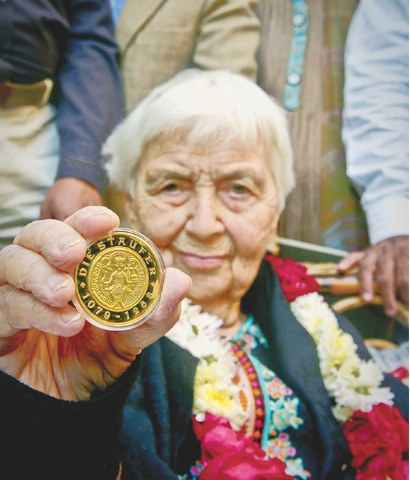 Dr Ruth Pfao showing award received from German Government